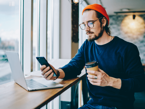 Person using TotalAV&trade; in a coffee shop